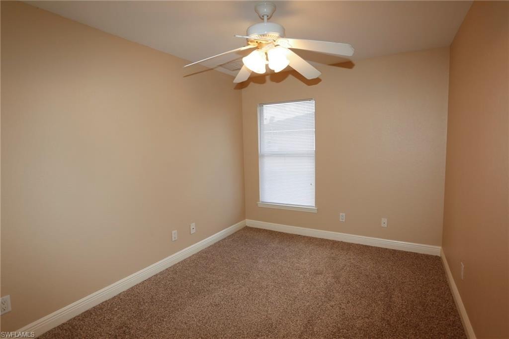 Neutral-toned walls complement the textured brown carpeting