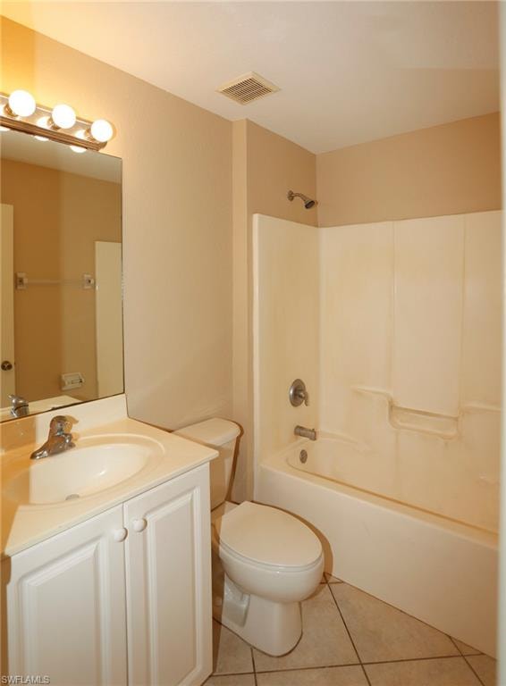 Bathroom featuring a white vanity with integrated sink, chrome faucet, wall-mounted mirror, and a combination tub/shower with chrome fixtures