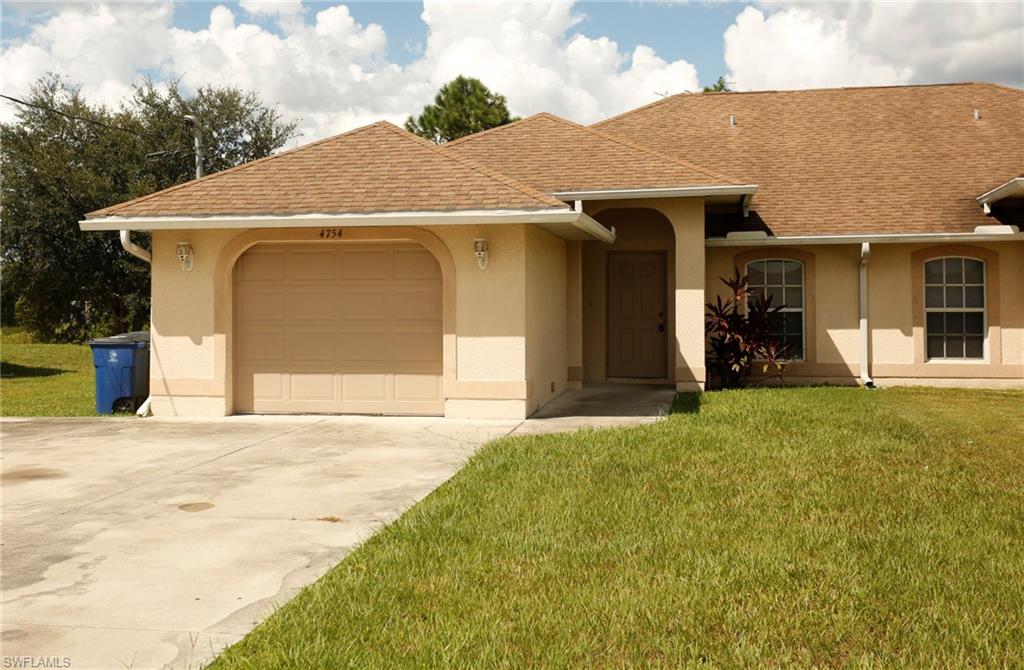 Exterior facade featuring a single-car garage, arched entryways, a shingle roof, stucco siding, and a concrete driveway