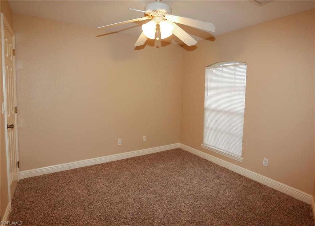 Neutral-toned walls complement plush brown carpeting