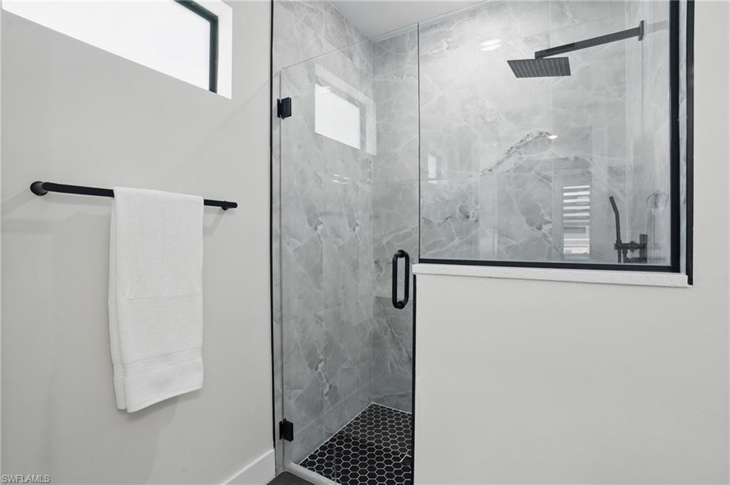 Bathroom with a marble finish shower