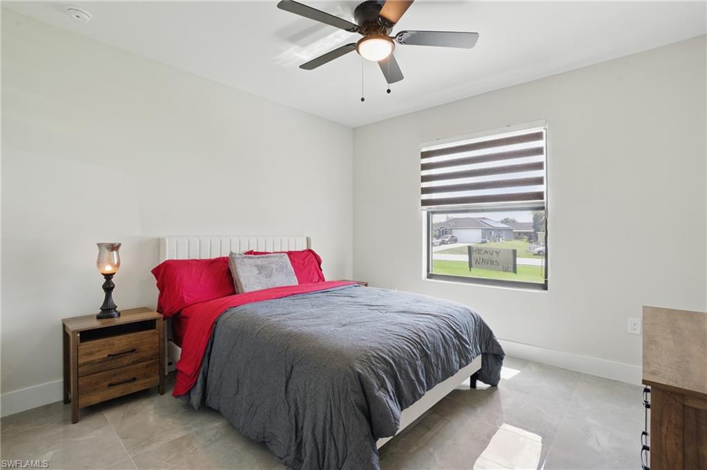 Bedroom with baseboards and a ceiling fan