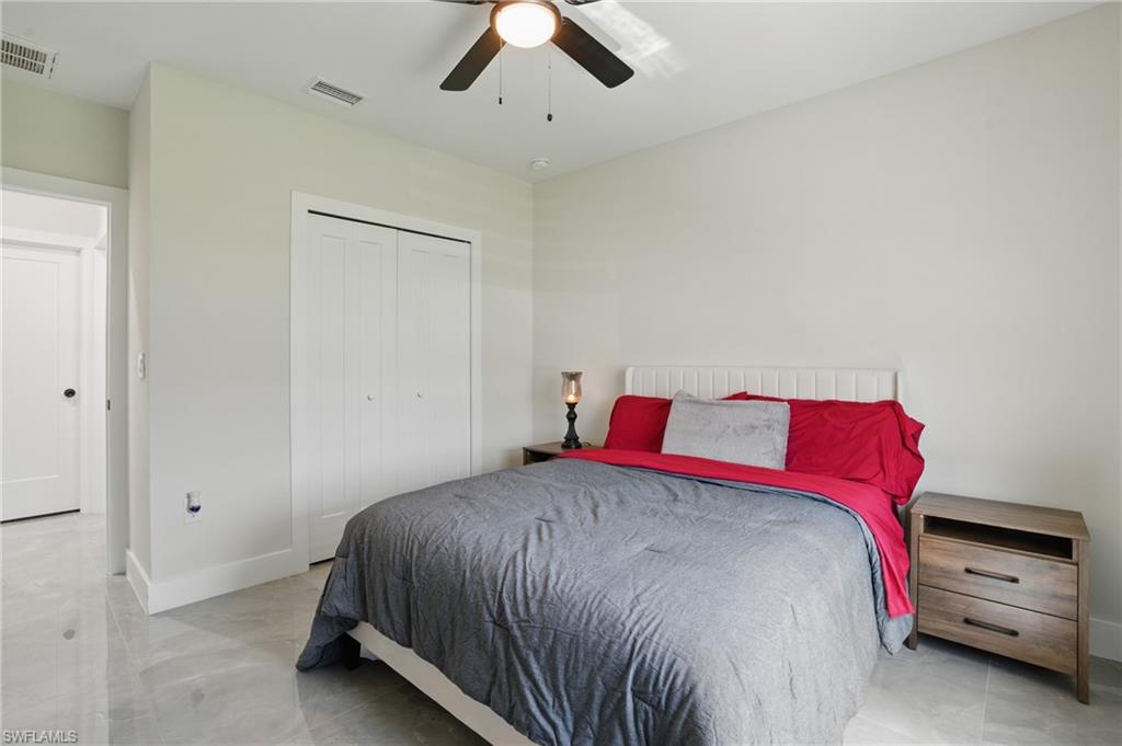 Bedroom with a closet, a ceiling fan, and baseboards