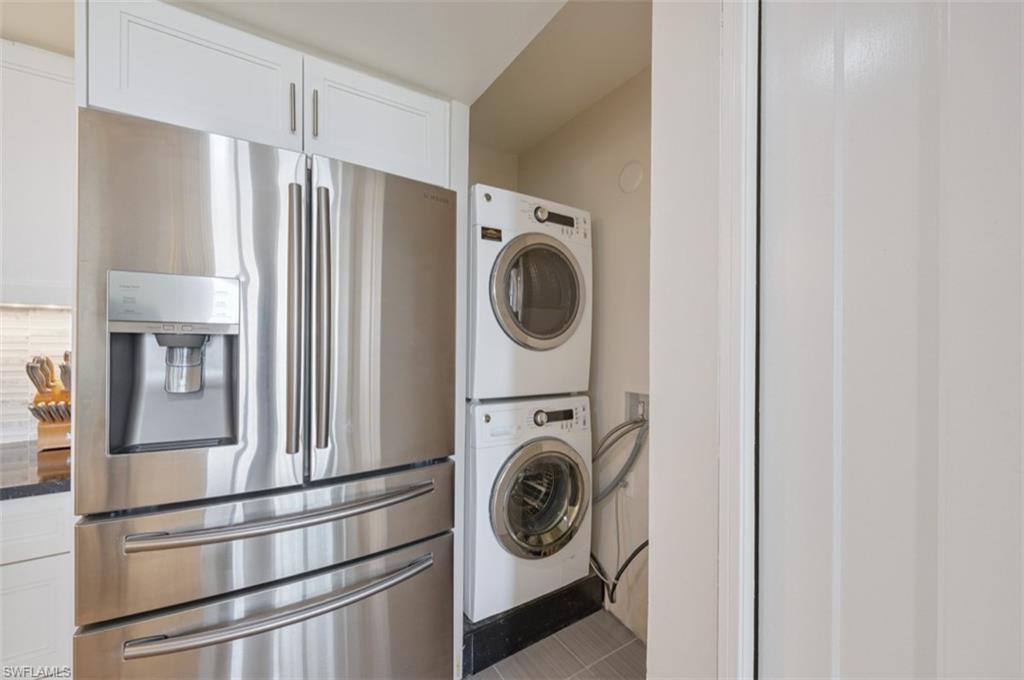 Laundry area featuring stacked washer and dryer