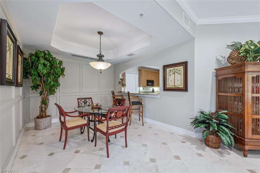 Dining room with a tray ceiling and crown molding