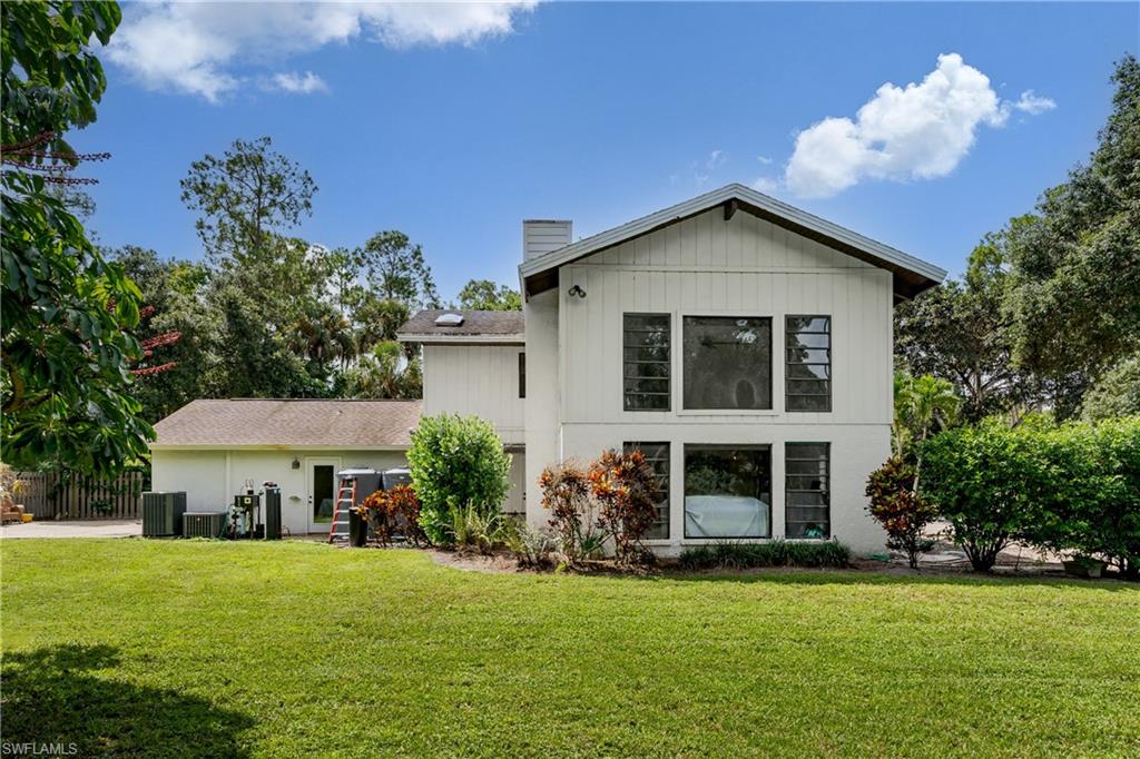 Expansive green lawn with mature trees and shrubbery