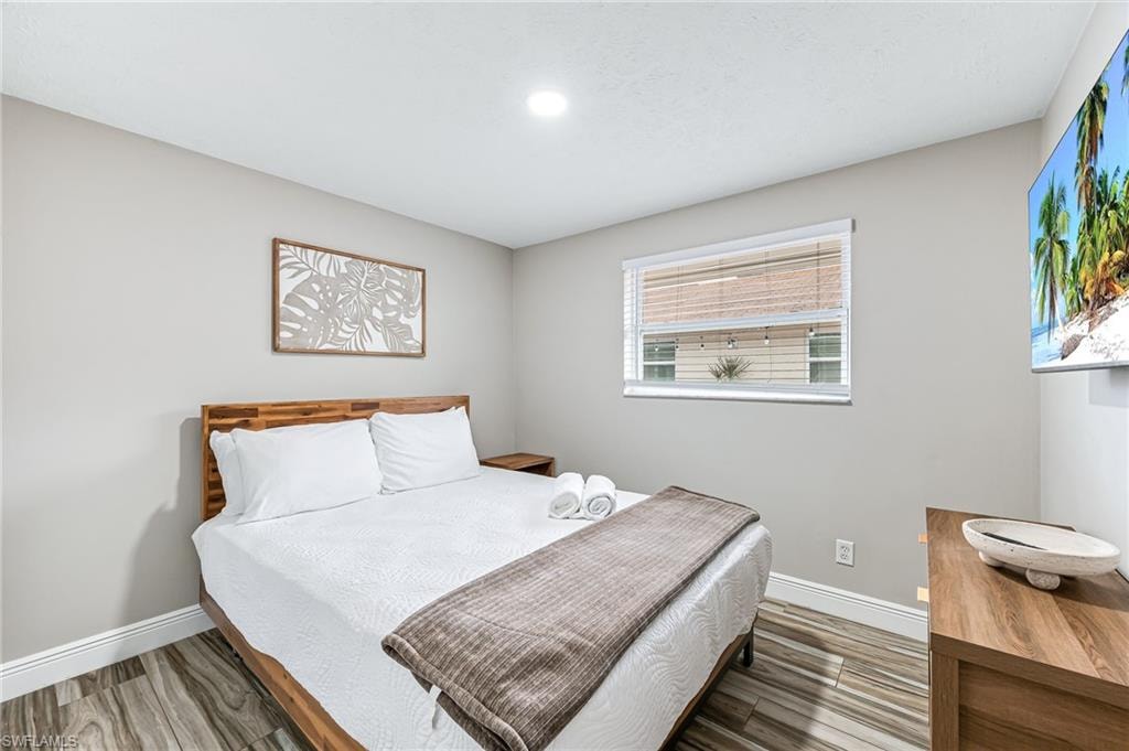 Bedroom with hardwood / wood-style floors