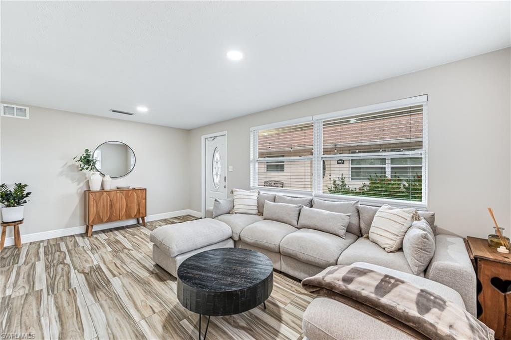 Living room with light hardwood / wood-style floors