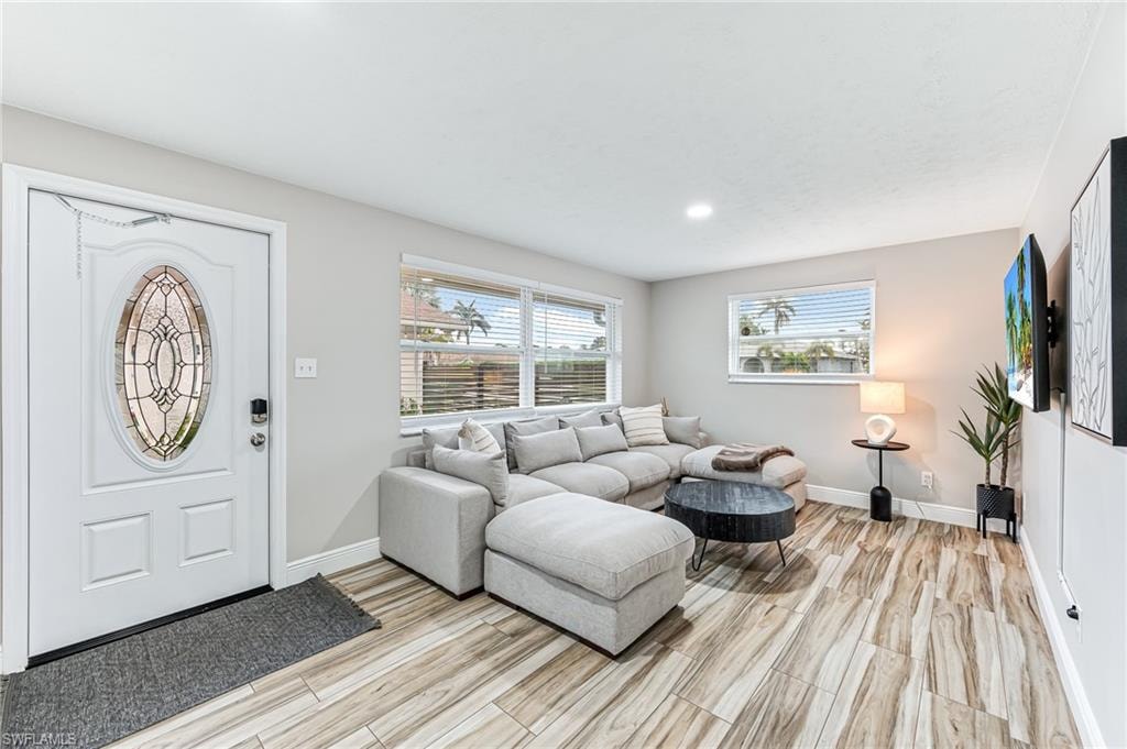 Living room with light wood tile floors throughout