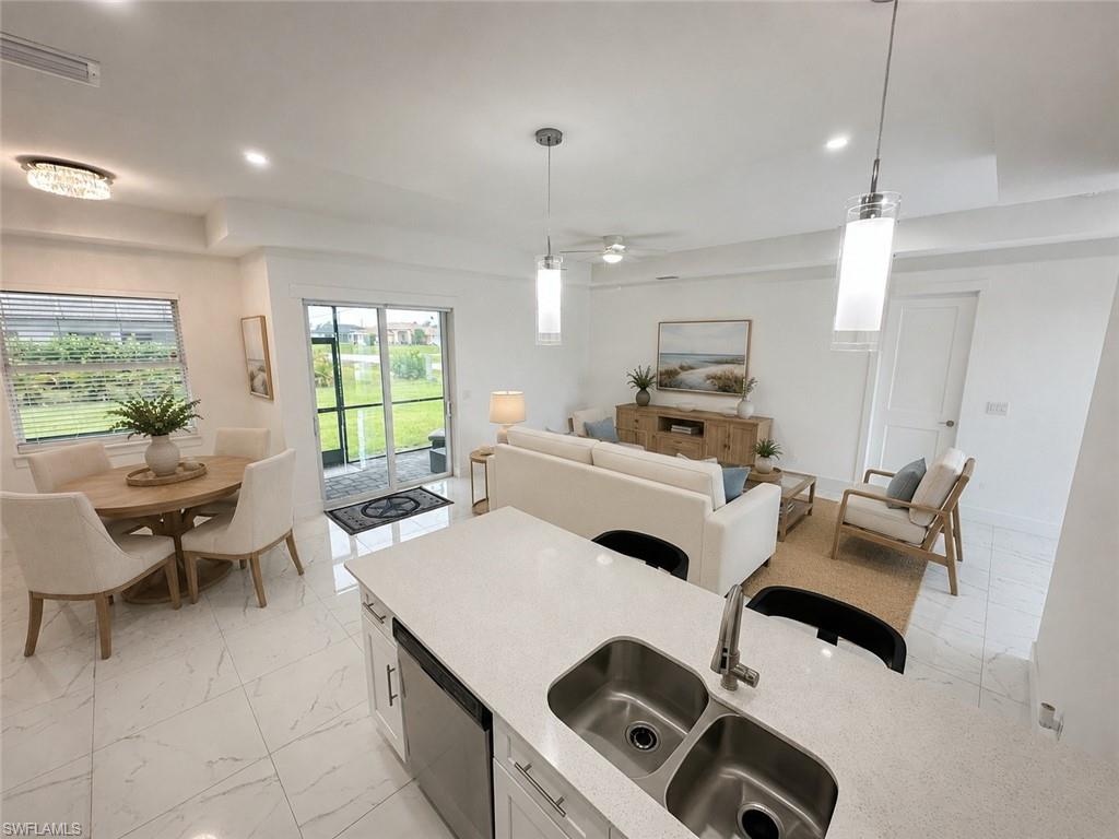 Kitchen island featuring a dual stainless steel sink and quartz countertop