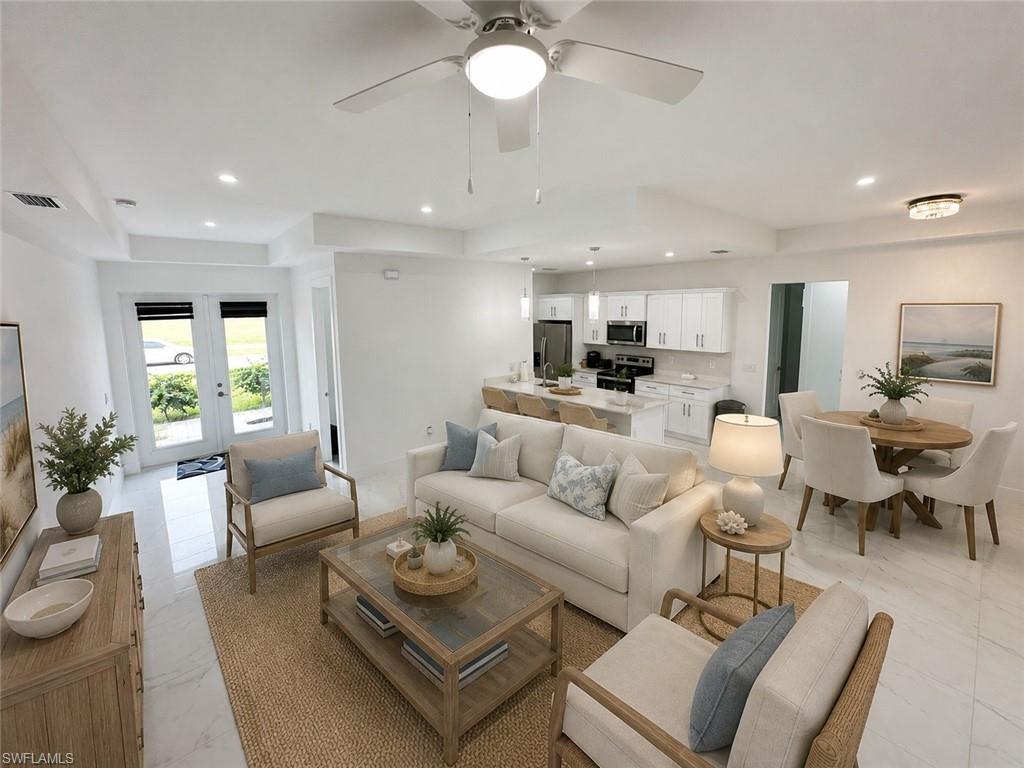 Open-concept living space featuring light tile flooring, recessed lighting, a modern ceiling fan, and white walls