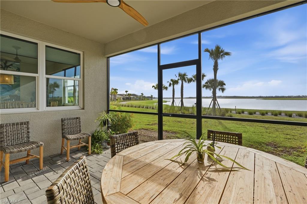 Screened patio featuring a ceiling fan, paver flooring, and extensive water frontage