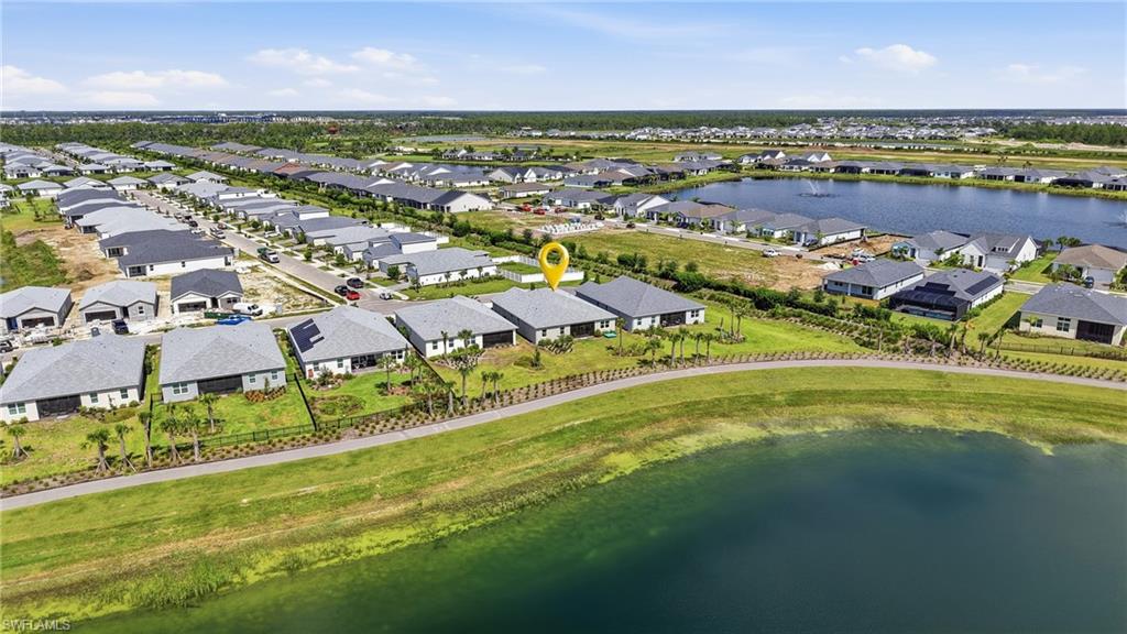 Property with a waterfront setting, featuring a structured shoreline and green space