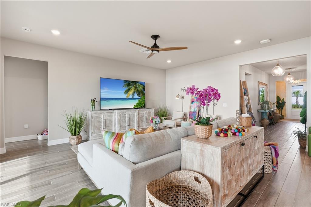 Recessed lighting throughout, wood-finish flooring, ceiling fan, and painted interior walls