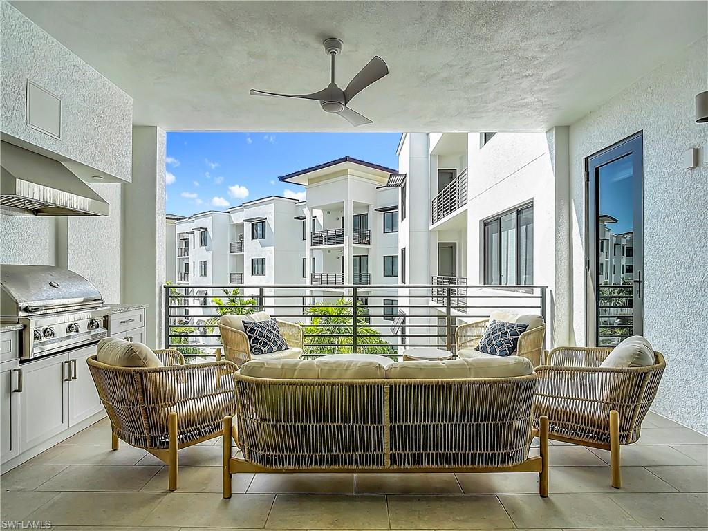 Balcony featuring ceiling fan, a grill, and outdoor lounge area