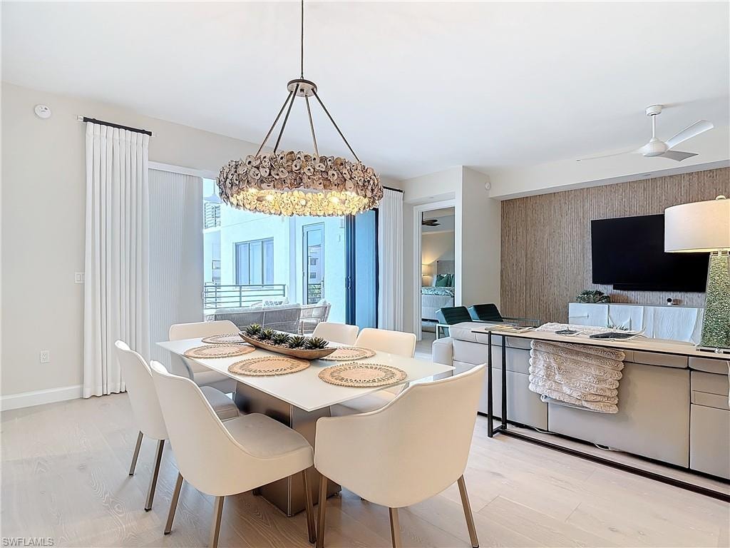 Dining room with light hardwood / wood-style floors and ceiling fan