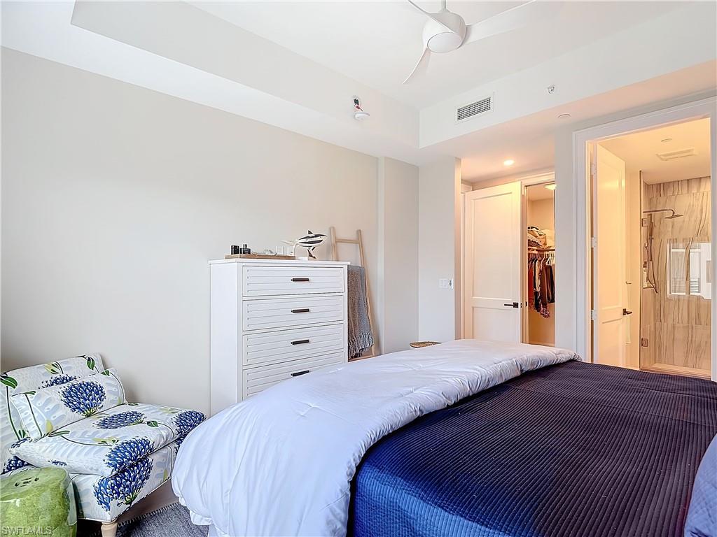 Bedroom featuring a closet, a spacious closet, and ceiling fan
