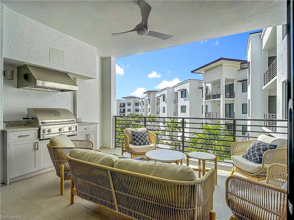 Balcony featuring area for grilling, an outdoor living space, an outdoor kitchen, and ceiling fan