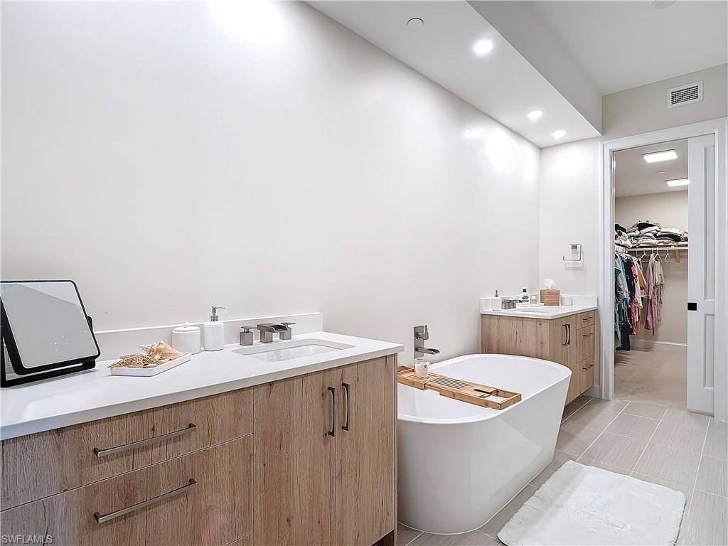 Bathroom with vanity and a tub