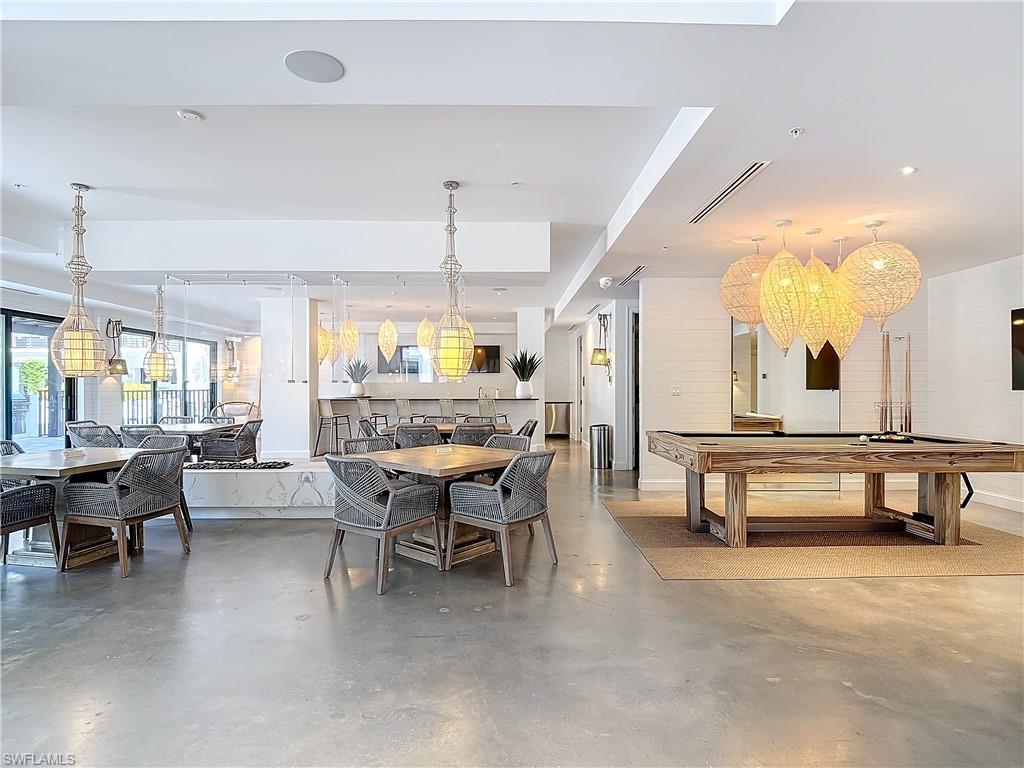 Dining room featuring pool table and concrete flooring