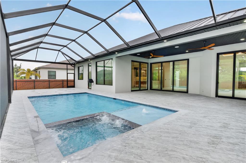 Screened lanai featuring a rectangular pool and integrated spa