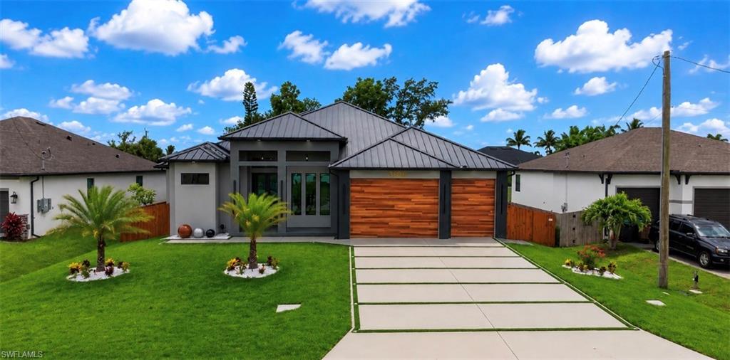 Modern architectural design with a dark metal roof and light gray stucco exterior