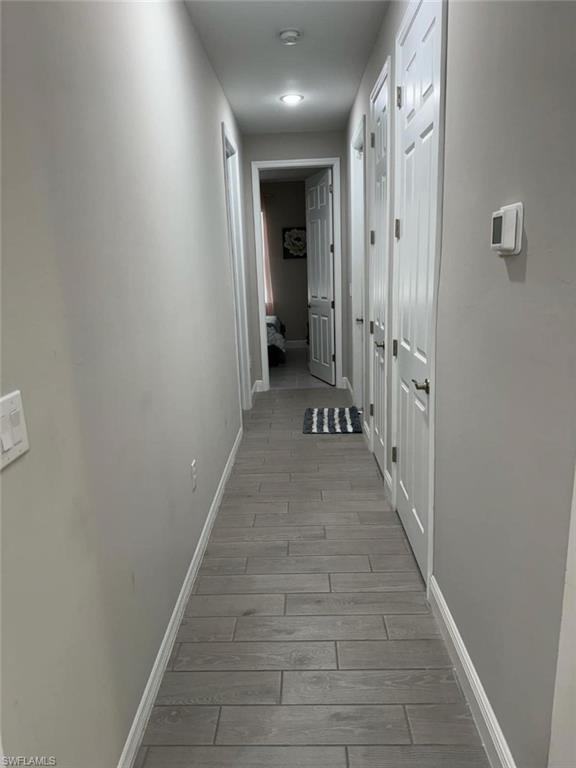 Hall with light hardwood / wood-style flooring