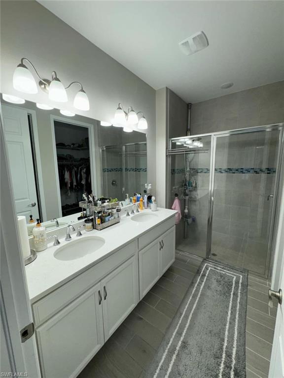 Bathroom featuring vanity and a shower with shower door