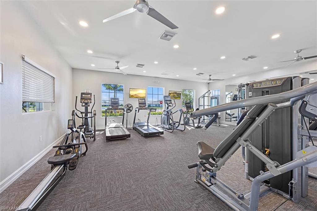 Exercise room featuring ceiling fan and carpet floors