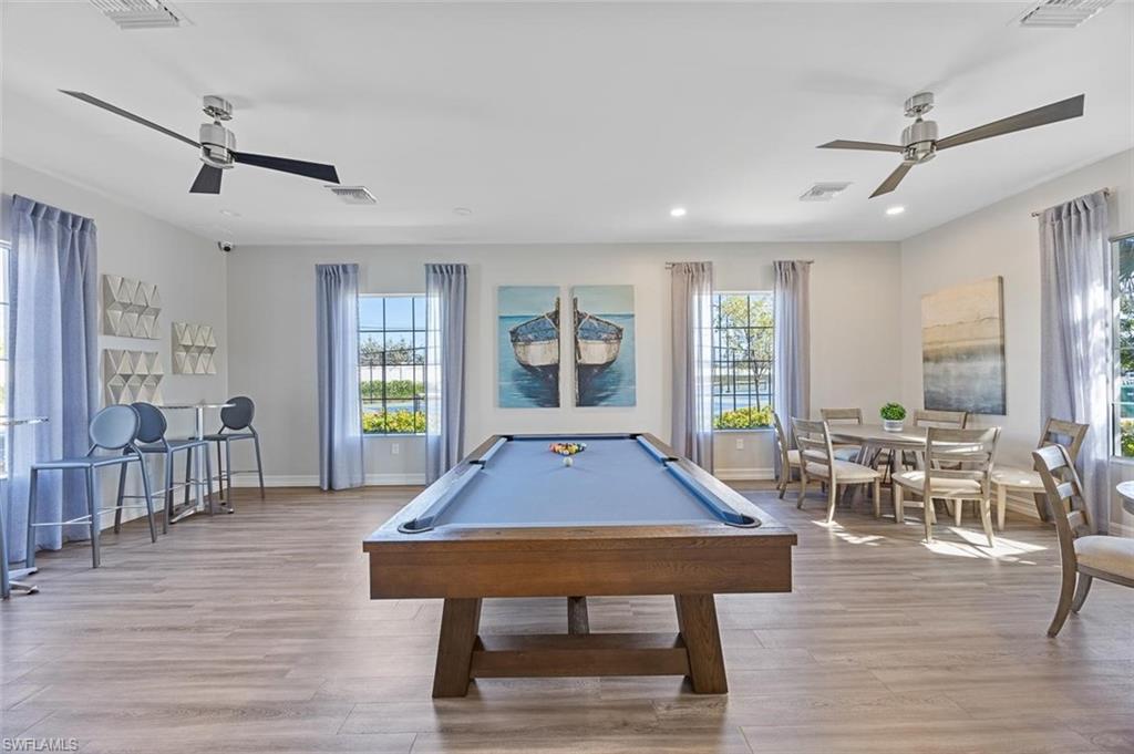 Game room featuring plenty of natural light, pool table, and light hardwood / wood-style flooring