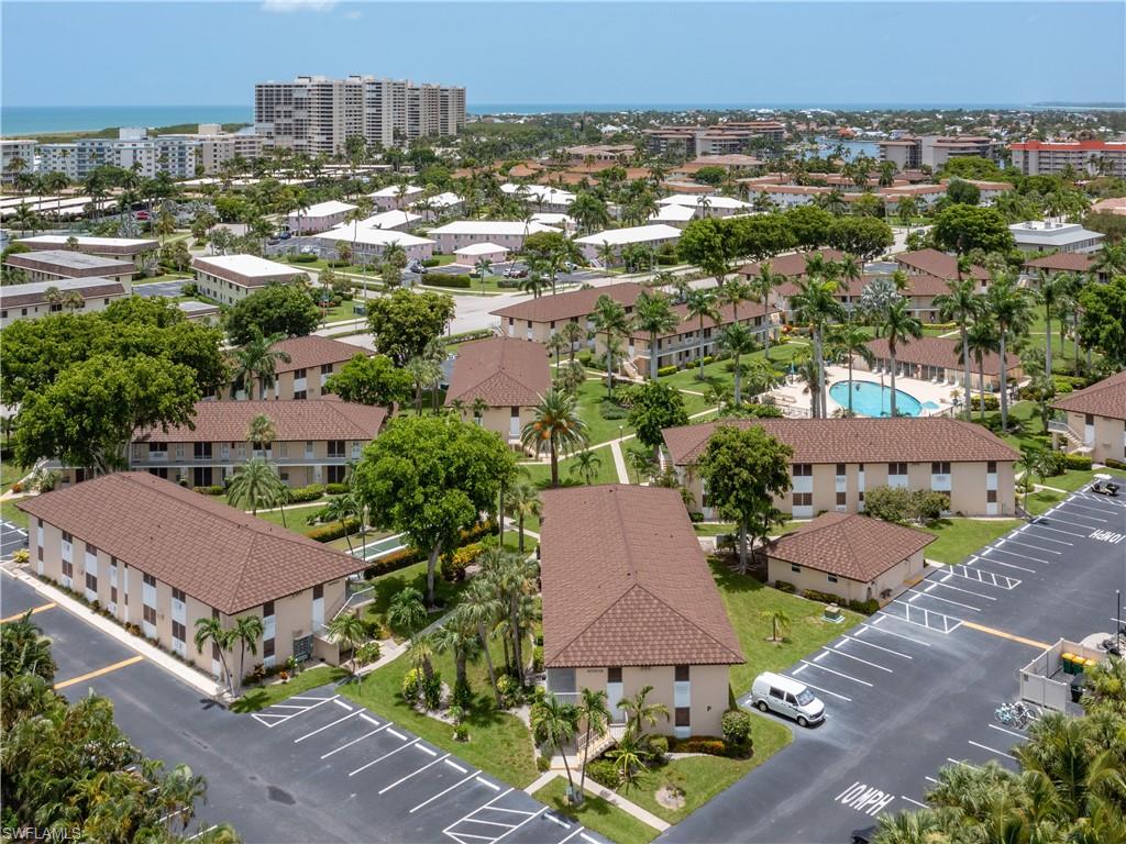Aerial perspective showcasing multiple low-rise buildings with complementary brown tile roofs and light-colored facades