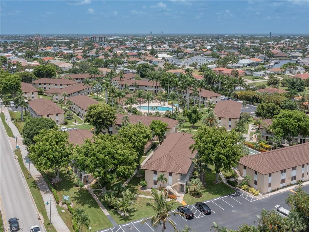 Aerial perspective showcasing a community of residential buildings with matching brown shingle roofs