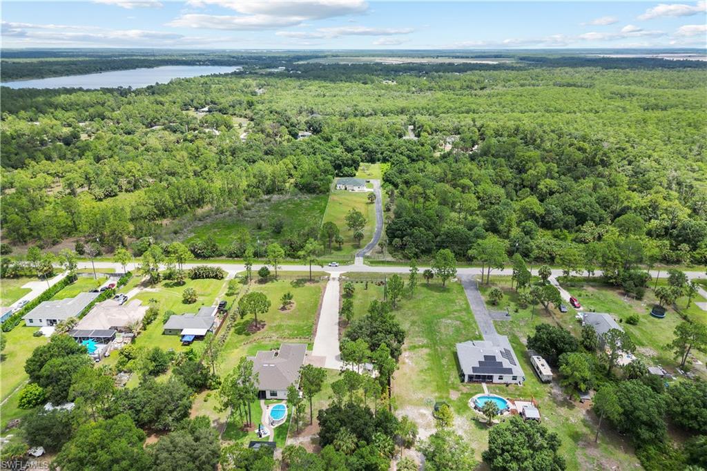 Aerial perspective showcasing a residential area amidst extensive green landscaping