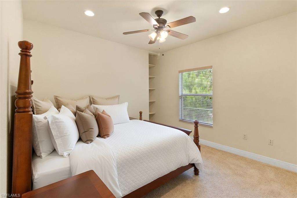 Carpeted room featuring a window with blinds, recessed lighting, and a ceiling fan