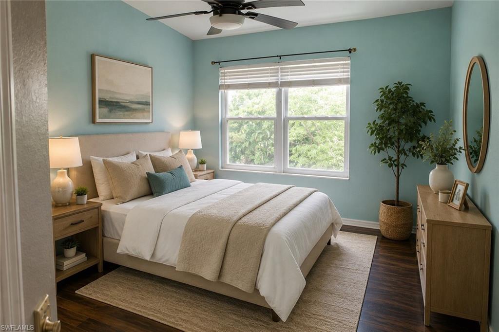 Spacious bedroom featuring wood-finish flooring and a vaulted ceiling with a ceiling fan