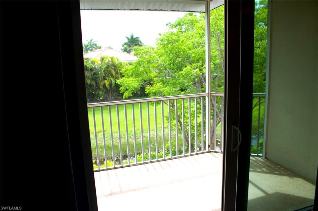 Balcony featuring a metal railing, concrete flooring, and sliding glass doors