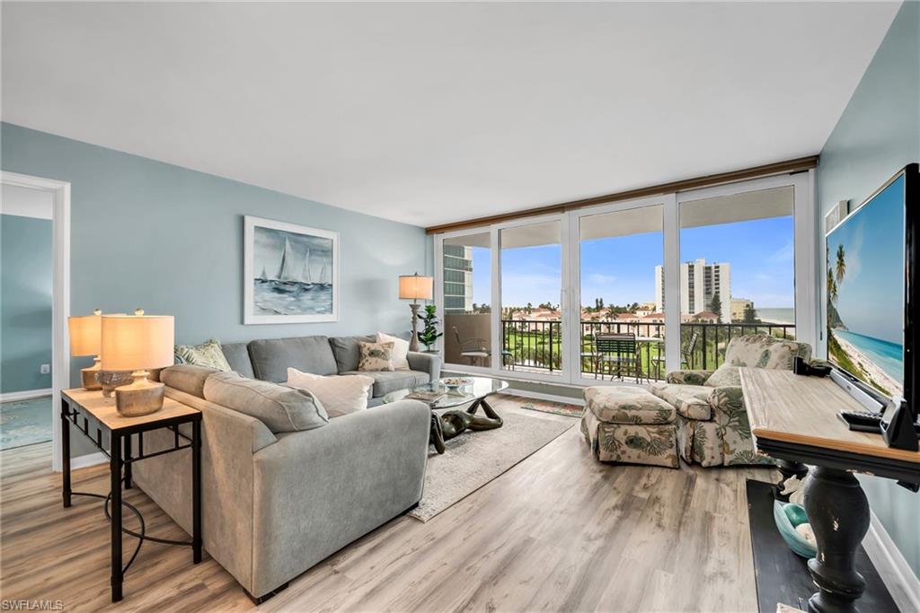 Inviting gathering space with expansive windows framing beautiful water and beach views.