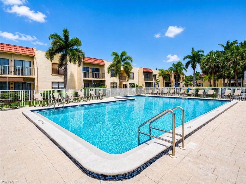 Outdoor swimming pool with tile surround and integrated entry rails