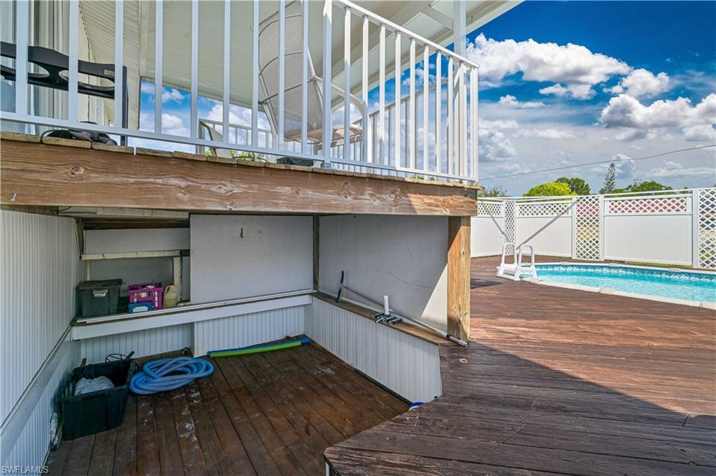 Outdoor swimming pool with a surrounding wood-finish deck
