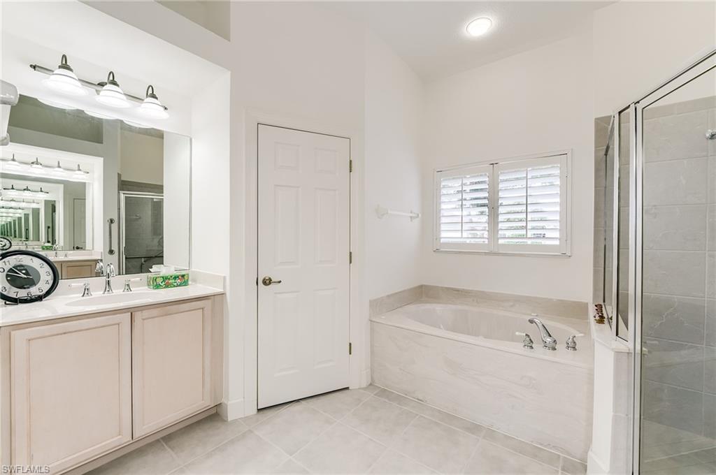 Primary bath with sink on the left and to the right of the soaking tub and shower is anotjher sink.