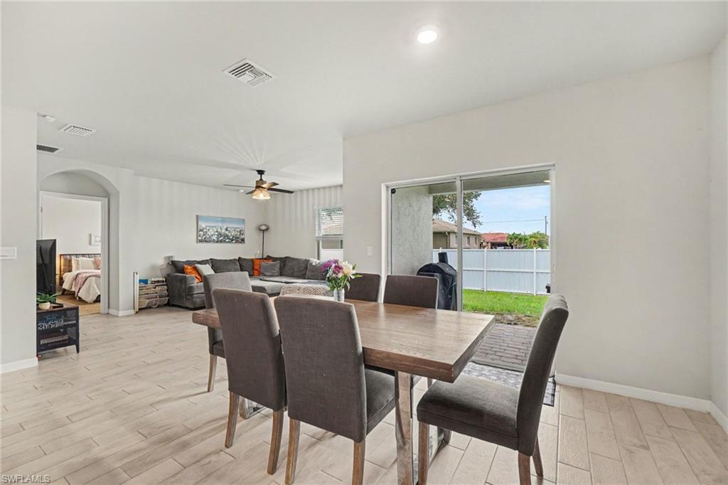 Open concept dining area with wood-finish flooring, recessed lighting, and sliding glass door access to the outdoor space