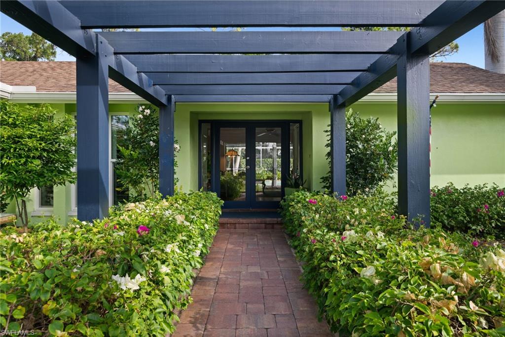 Lush landscaped walkway creates a welcoming approach to the home’s private entrance.