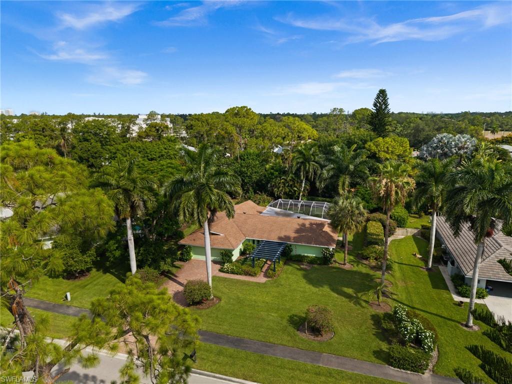 Set on a private, oversized lot framed by tropical landscaping