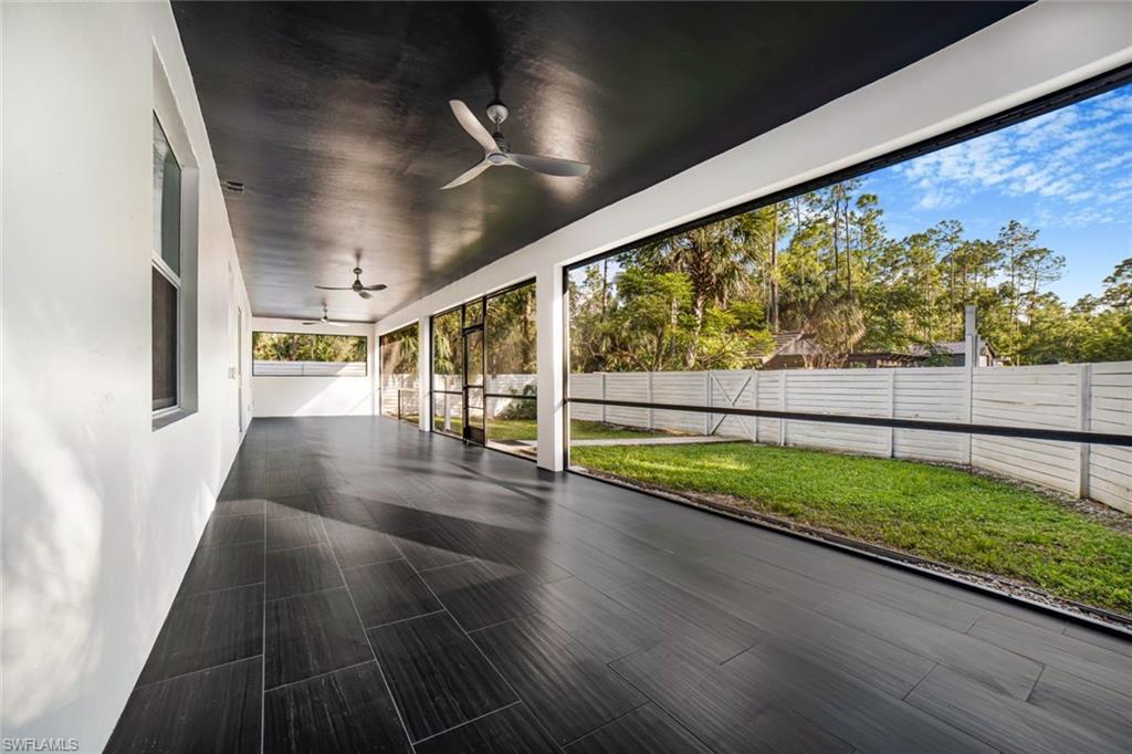 Unfurnished sunroom with ceiling fan