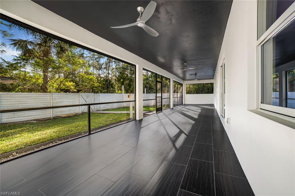 Unfurnished sunroom with ceiling fan