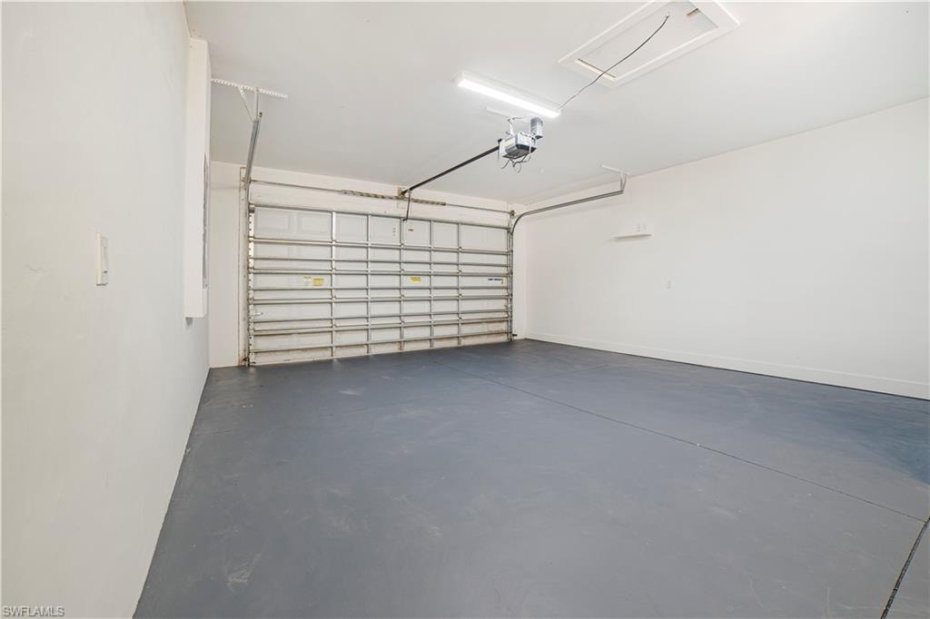 Garage featuring a garage door opener