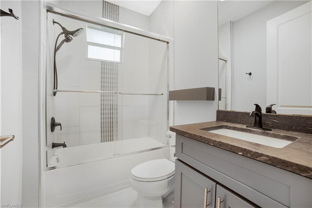 Full bathroom with vanity, combined bath / shower wi
