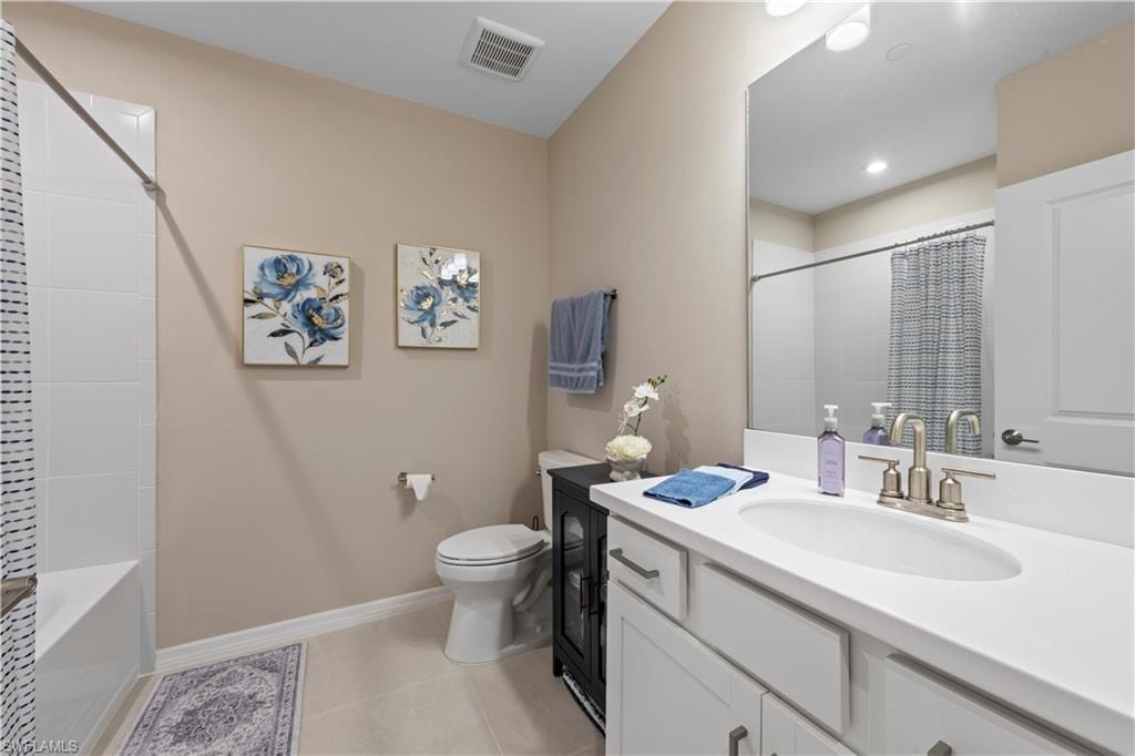 Guest Bathroom featuring a single vanity with an integrated sink, brushed nickel faucet, and a large mirror