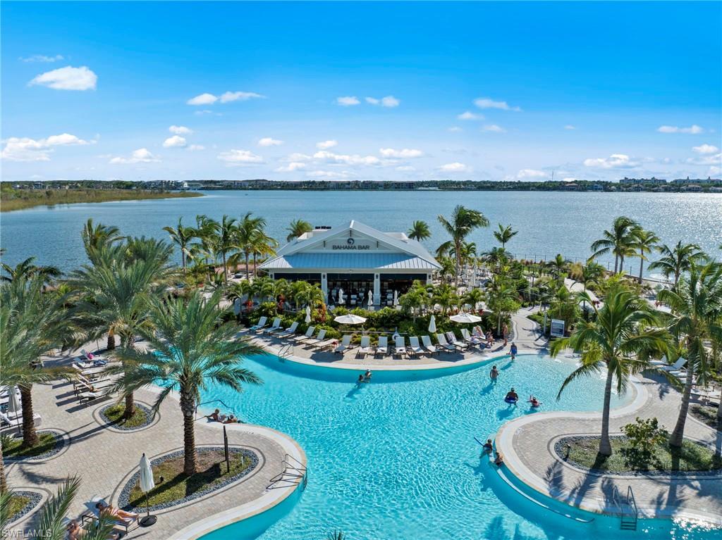 Welcome to Esplanade Lake Club! Located on Lake Como, Expansive aquatic amenity featuring a large resort-style pool with integrated lounging areas, surrounded by mature palm trees and paver decking and tons of amenities. See more amenities at end of photos.