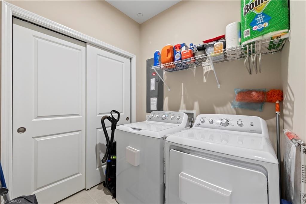 Laundry area featuring a wire storage shelf, built-in panel doors, and neutral wall tones